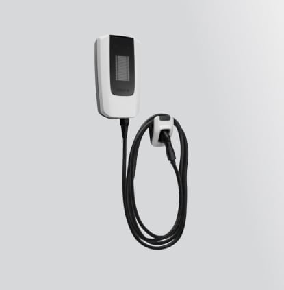 Wall-mounted electric vehicle charger with attached charging cable on a gray background.